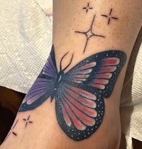 a butterfly tattoo on a woman's foot